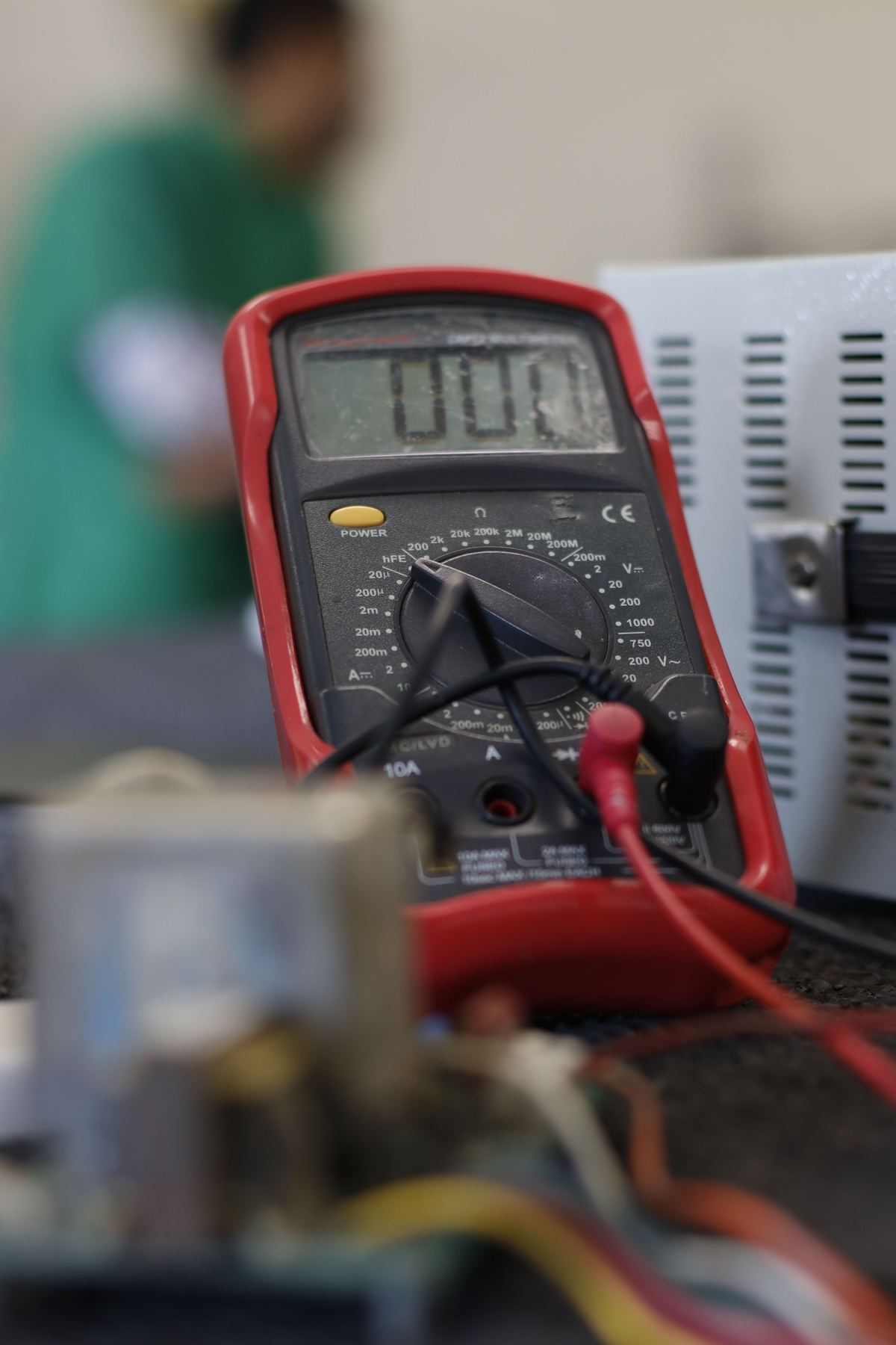 Multimeter testing electrical equipment for PAT testing